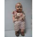 A Mid XX Century Composition Baby Doll, stamped H.W. 102/50. Sleepy eyes and open mouth with