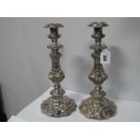 A Highly Decorative Pair of Plated Candlesticks, each shaped circular base supporting square