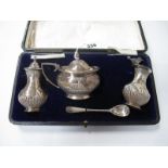 A Chester Matched Hallmarked Silver Three Piece Cruet Set, complete with spoon in original fitted