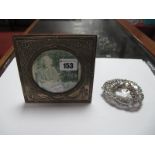 A Hallmarked Silver Mounted Photograph Frame, with circular aperture, on wooden easel back; together