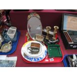 An Oval Bevelled Barbola Easel Mirror, advertising tins and brewery ashtray's, brass candlesticks,