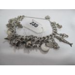 A Curb Link Charm Bracelet, suspending numerous novelty charm pendants.