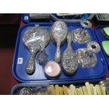 Decorative Hair Brushes, a hand mirror, allover detailed in relief, a pair of dwarf candlesticks,