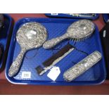 A Hallmarked Silver Backed Four Pine Dressing Table Set, (damages). (4)