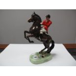 A Beswick Pottery Equestrian Figure of Rearing Brown Horse, surmounted by red jacketed male rider,