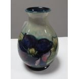 A Moorcroft Pottery Floral Pattern Vase, of bulbous form, on pale and dark blue ground, bearing W.