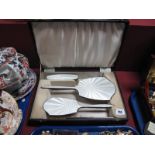 A White Enamel Backed Three Piece Silver Dressing Table Set.