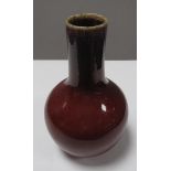 A Stoneware Bottle Vase, with sang-de-boeuf type glaze, 25cm high.