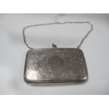 A Decorative Ladies Purse, of rounded rectangular form, all over leaf scroll engraved, with purple