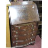 A Reprodux Mahogany Bureau, with fall front, fitted interior over four serpentine fronted drawers.