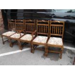 One Carver and Four Single Spindle Back Dining Chairs.