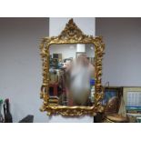 A Gilt Roccoco Style Wall Mirror, with C-scroll decoration, together with a print .(2)