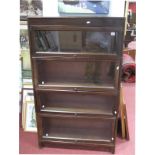 A Gunn Four Heights Mahogany Sectional Bookcase, with glazed sliding doors.