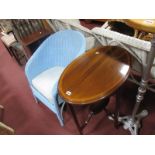 An Edwardian Mahogany Oval Topped Occasional Table, including a painted basket chair. (2)