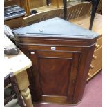 A XIX Century Mahogany Corner Wall Cupboard, having canted corners, William 4th mahogany dining