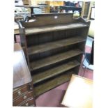 A 1920's Oak Bookcase, with three quarter gallery back, four open shelves, on bracket feet.