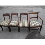 A Set of Three Mahogany Sabre Leg Chairs, with drop in seats; together with a mahogany elbow