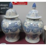 A Pair of Chinese Blue and White Pottery Ginger Jars, with cover, 43cm overall.