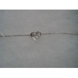 Tiffany; A Modern Platinum and Diamond Set Heart Bracelet, set with three graduated brilliant cut