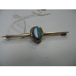 An Opal and Diamond Set Bar Brooch, the oval opal in matrix claw set within pear shape border of old