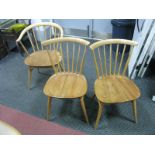 An Ercol Light Ash Four Comb Back Dining Chairs, pair of matching armchairs. (6)