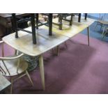 An Ercol Light Ash Extending Dining Table, on splayed legs, (top stained).