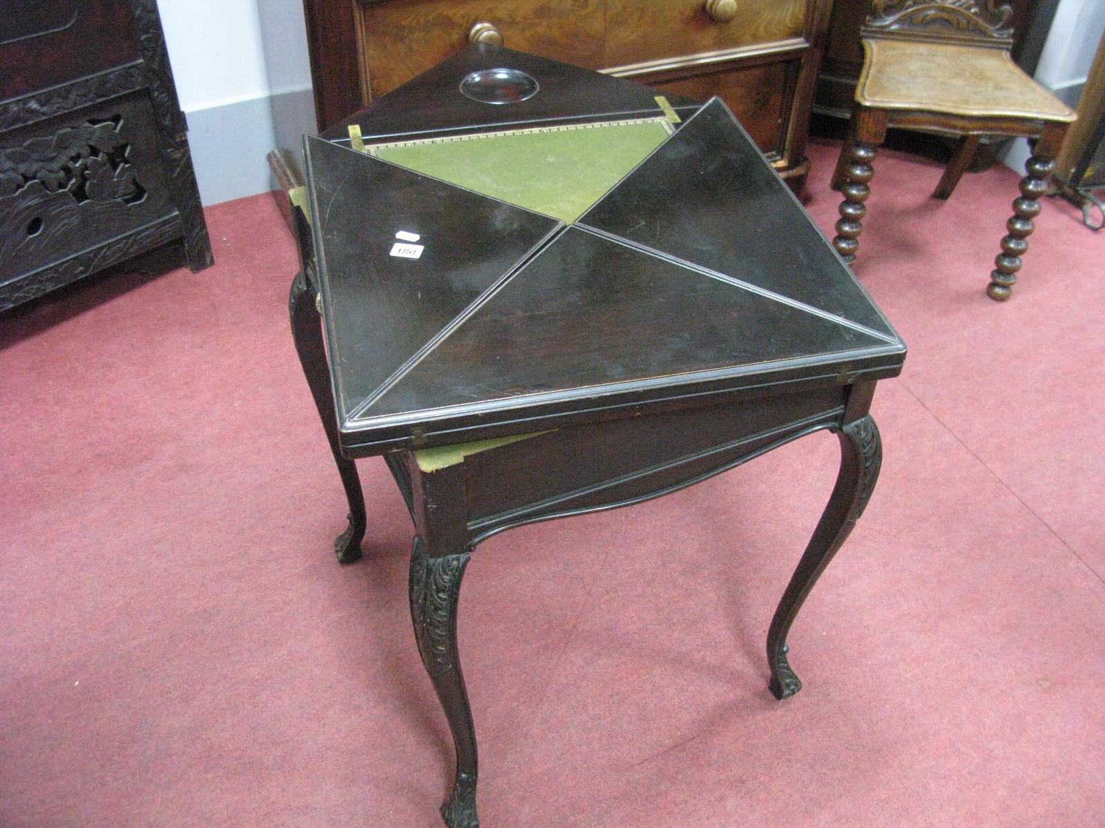 A Late XIX Century Ebonised Fold-Over Card Table, with four lift-up flaps concealing baize interior,