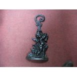 A Cast Iron Doorstop of a Cherub, C scroll handle.