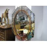 A Decorative Oval Bevelled Wall Mirror, in the Victorian style with four florets to pink tinted