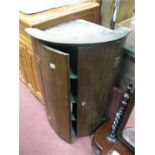 A XIX Century Oak Corner Wall Cupboard, with cylinder front, dentil cornice, quadrant shelves, 91.