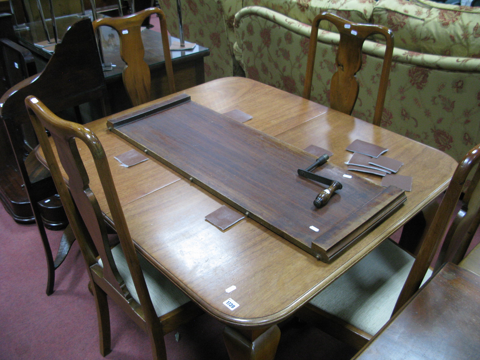 A 1920's Mahogany Extending Dining Table, with wind out action, spare leaf, on cabriole legs,