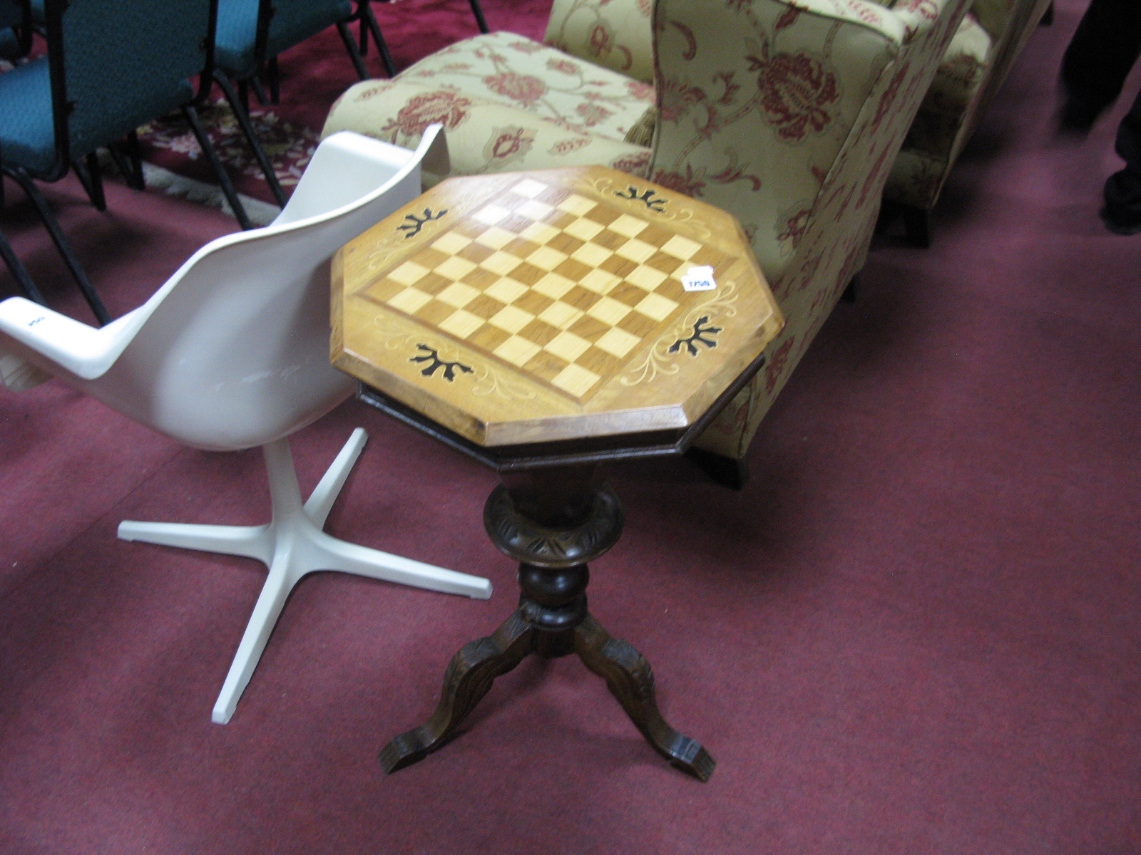 A XIX Century Walnut Work Table, with check board to octagonal top, carved baluster and tripod