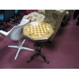 A XIX Century Walnut Work Table, with check board to octagonal top, carved baluster and tripod