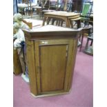 A Georgian Mahogany and Oak Corner Wall Cupboard, with stepped pediment, single door and three