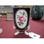 A Royal Worcester Spill Vase, hand painted with a rose, signed E. Phillips, raised on three paw feet