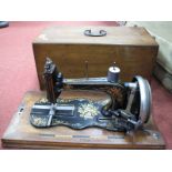 A Late XIX Century Sewing Machine, in a walnut case.