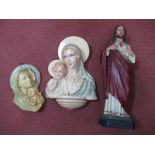 A Plastic Religious Figure, 41.5cm high, two similar wall plaques.