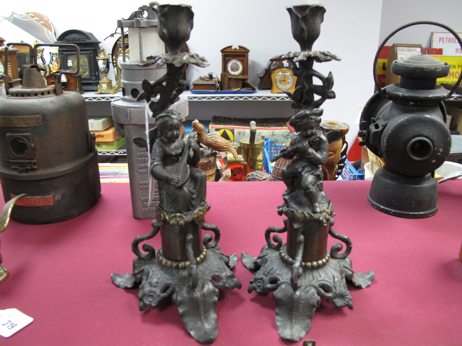 A Pair of Victorian Style Metal Candlesticks, with musicians as supports, 32cm high.