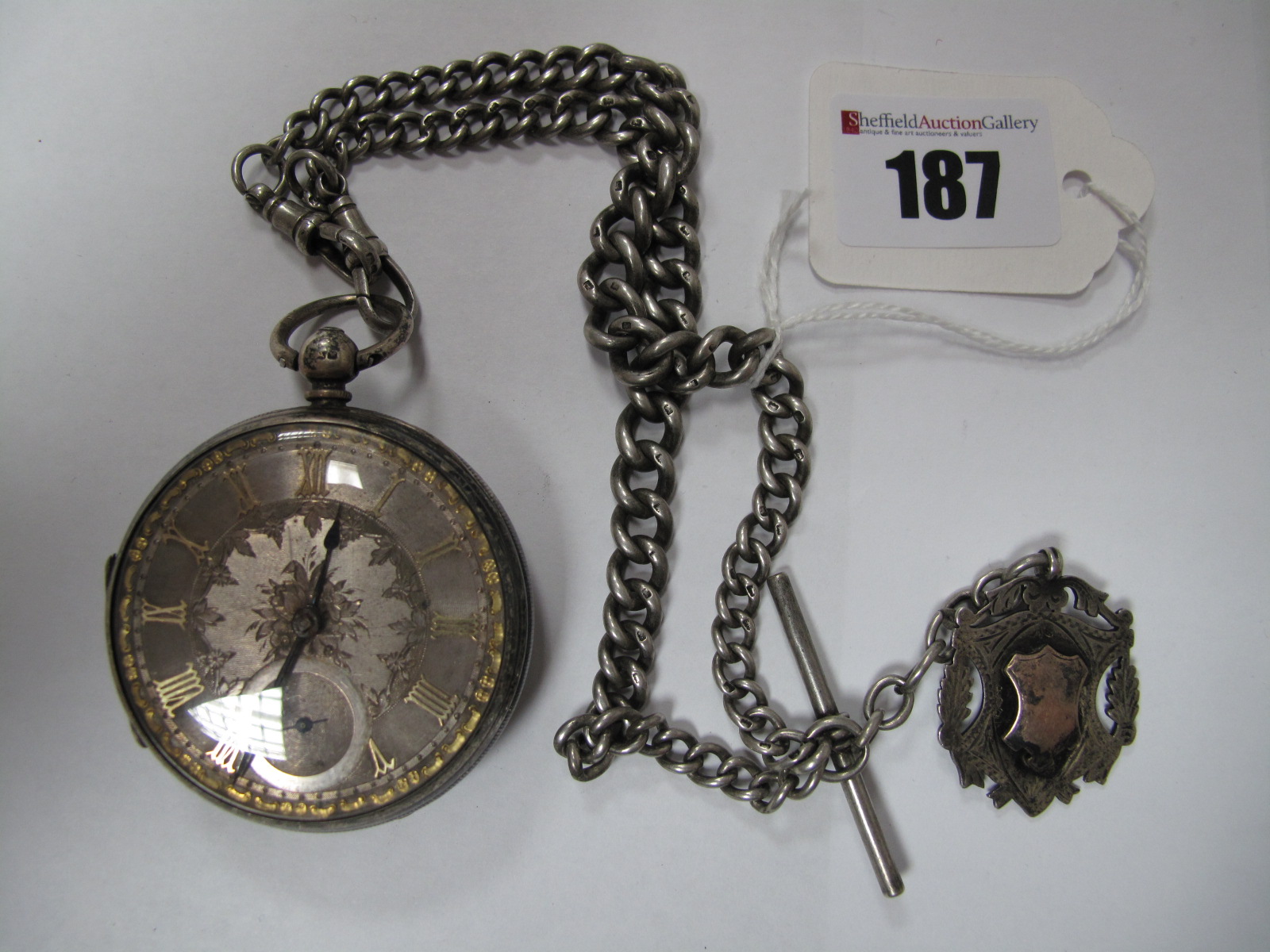A Hallmarked Silver Cased Openface Pocketwatch, the foliate engraved dial with Roman numerals and