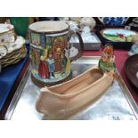 A 1930's Burleigh Ware Indian in Canoe Posy, together with a Beswick 1972 Christmas mug. (2)