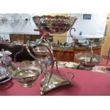 A Plated Table Centre Piece, with a pierced bowl and three plated bon bon baskets, shaped base on