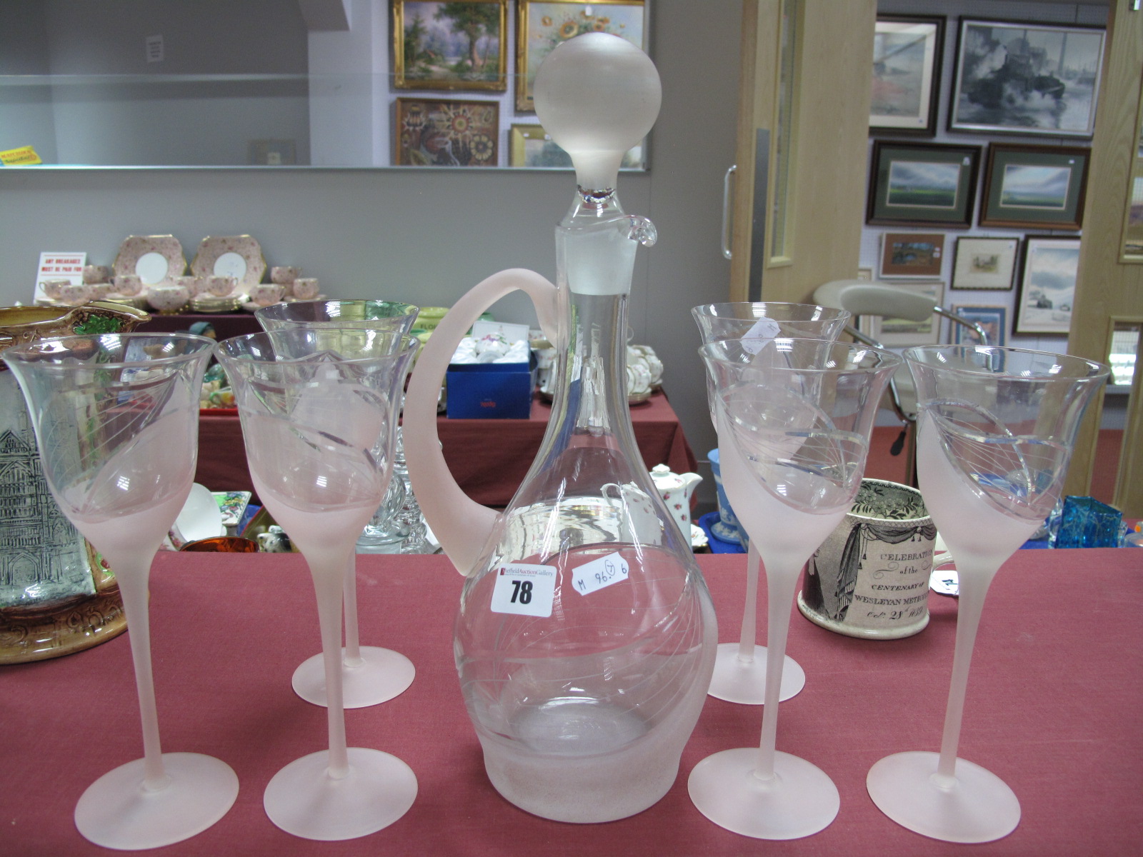 A Pink Frosted and Clear Glass Carafe, (cracked); together with six long stemmed wines.