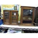 Two Early XX Century Oak Cased Smokers Cabinets, each with glazed doors and short drawers within. (