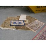 A Chinese Wool Prayer Mat, three tasselled rugs, larger floral rung with canted corners. (5)