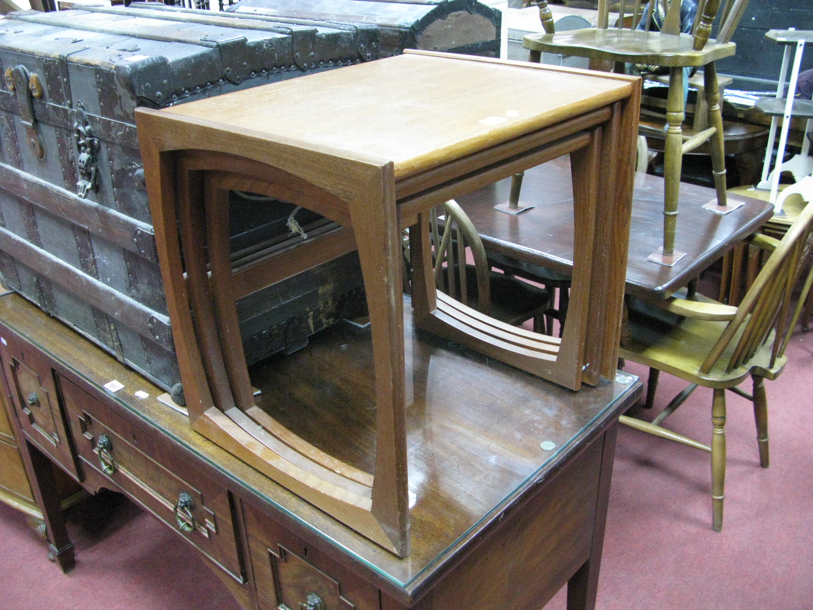 A Nest of Teak Coffee Tables, with shaped supports.