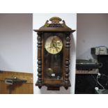 A XIX Century Walnut Vienna Wall Clock, with applied top, glazed door, circular dial, Roman