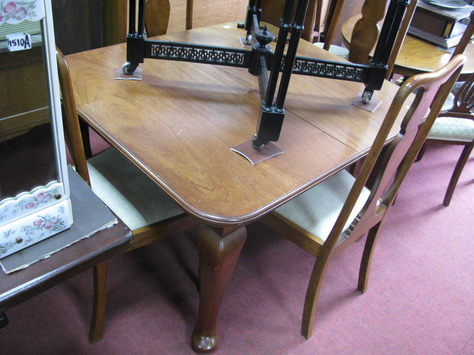 A 1920's Mahogany Extending Dining Table, with wind out action, spare leaf, on cabriole legs,