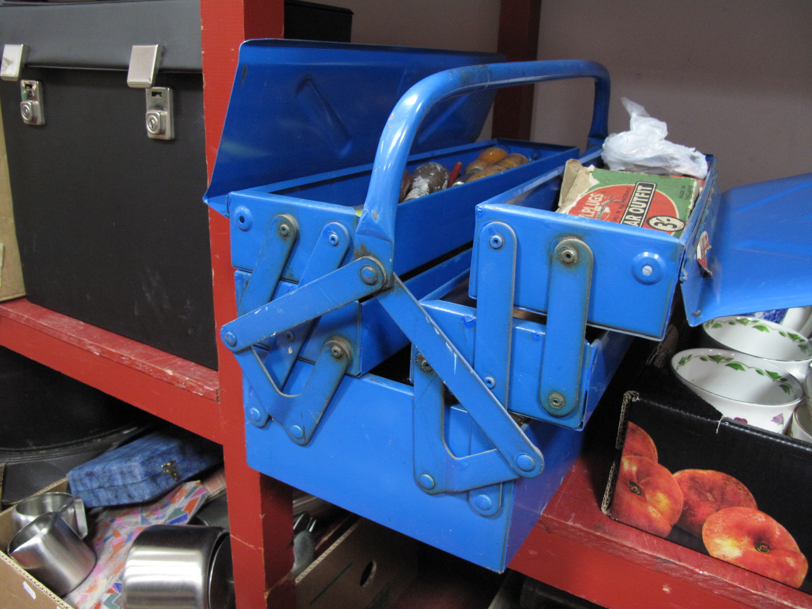 Files, Hammer, Screwdrivers etc, in a blue folding tool box.