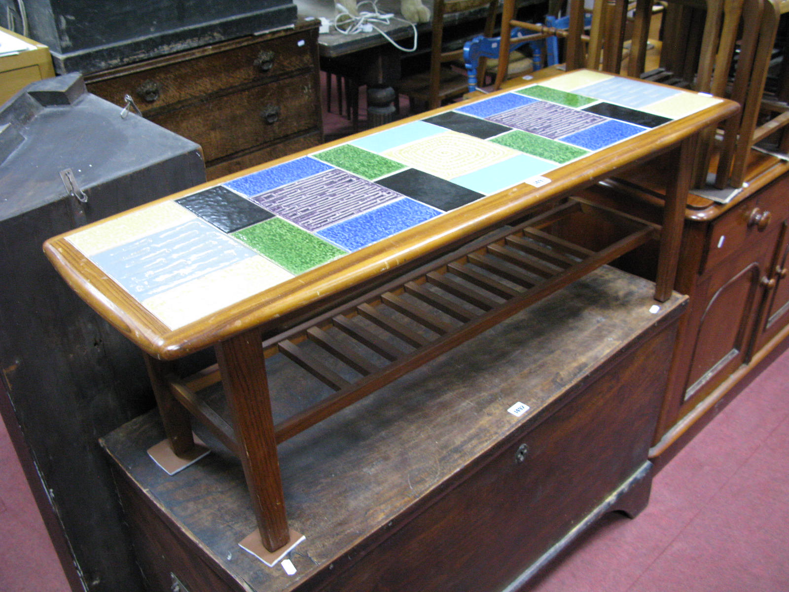 A Teak Coffee Table, with multicoloured ceramic tile inset top, circa 1970's, on tapering legs