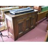 A 1920's Oak Sideboard, with a low back, two carved top drawers, over three panelled carved cupboard